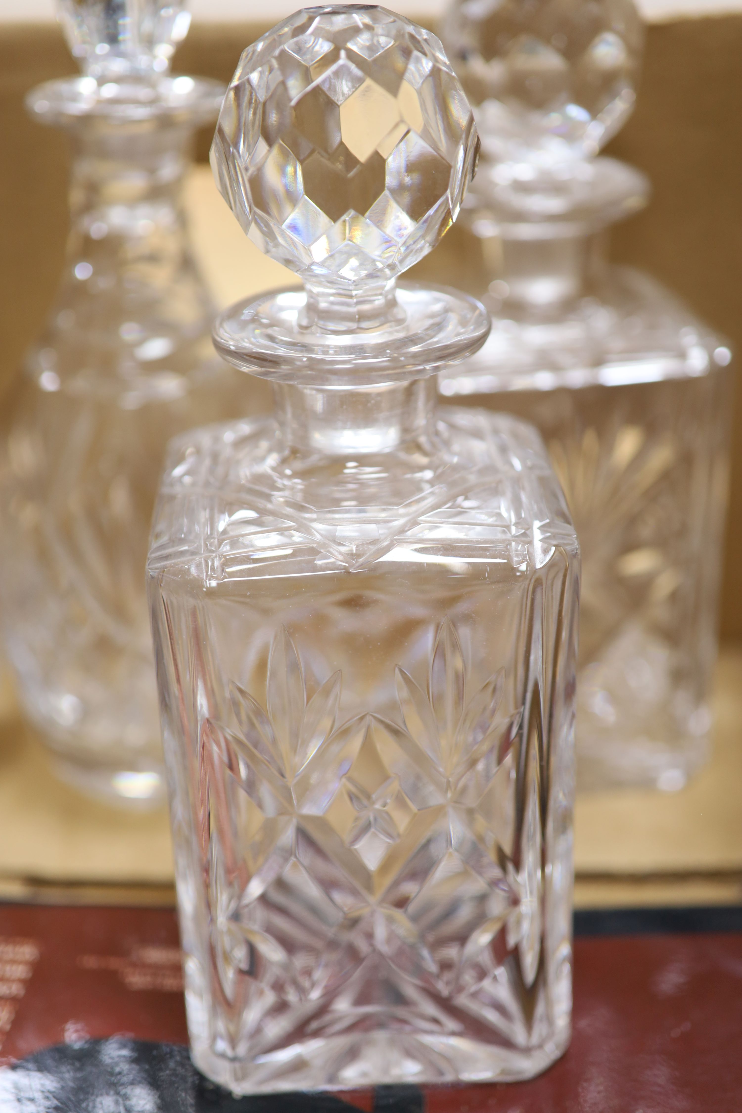 Five various glass decanters and a similar claret jug